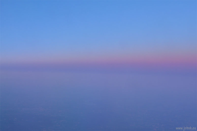 View from an airplane as the sun sets